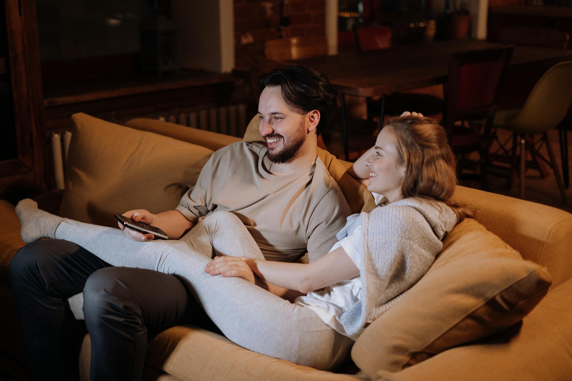 man and woman sitting on couch